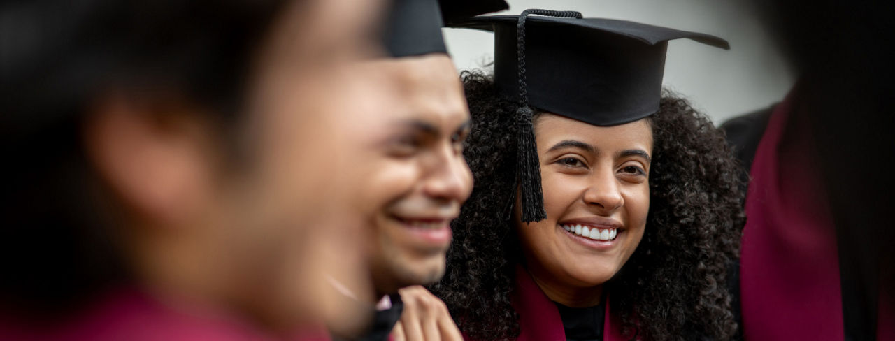 A woman in a graduation cap and gown.