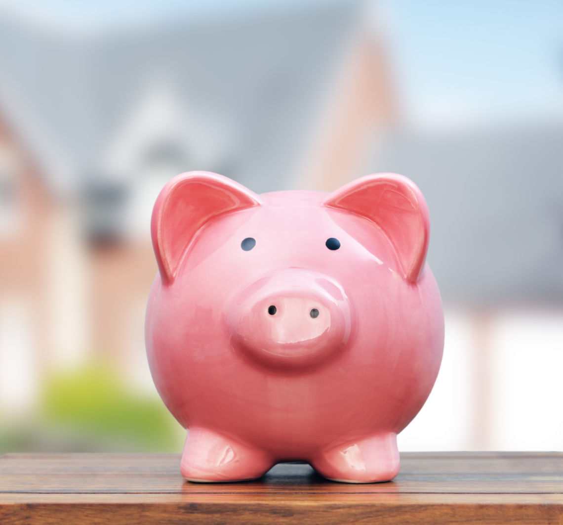 Pink piggy bank on tabletop