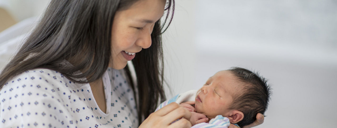 A woman holding her newborn baby.