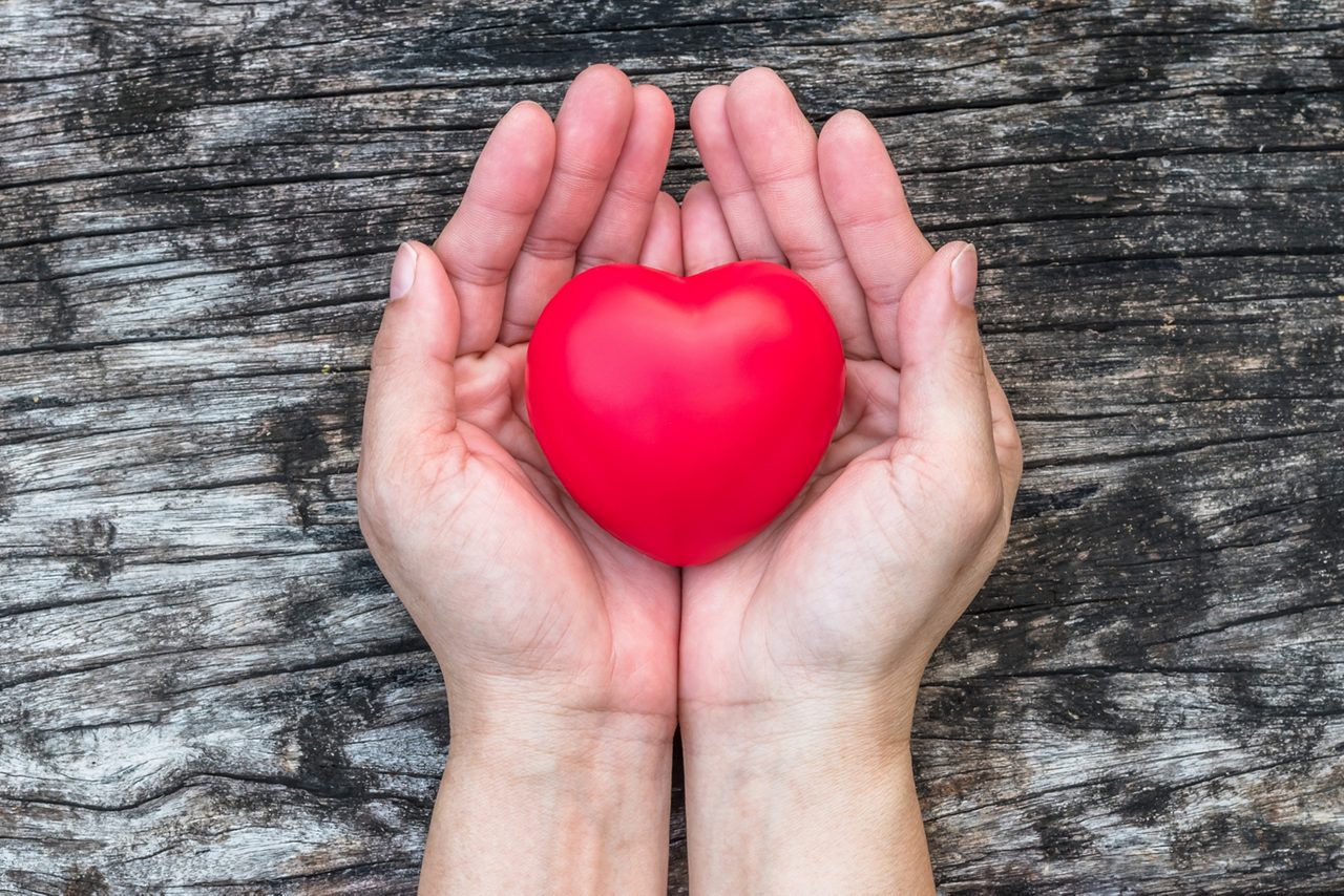 hands holding a red heart