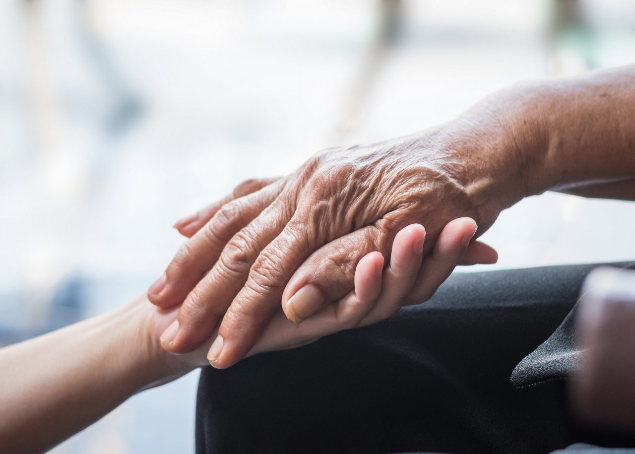 Parkinson disease patient, elderly senior person in support of nursing family caregiver for disability awareness day concept