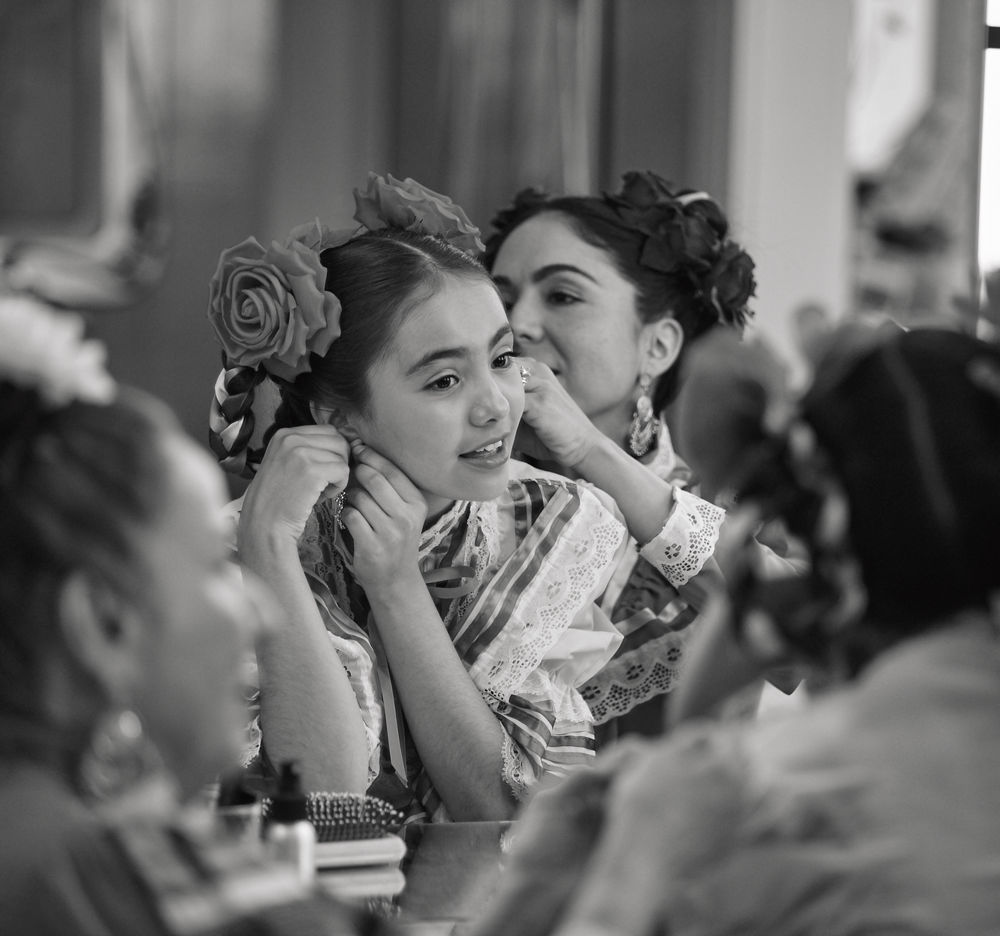 Mother helping daughter with her hair