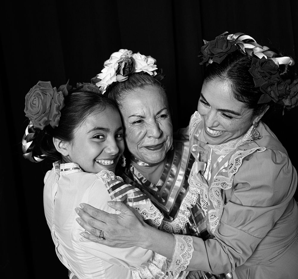 Grandmother, mother, and daughter hugging