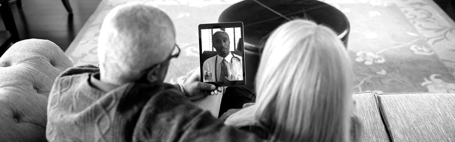Older couple video chatting with digital tablet