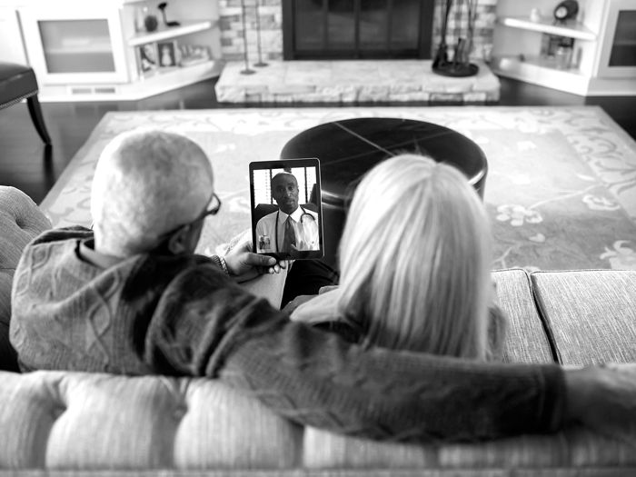 Senior couple on couch enjoying an online Medicare event 