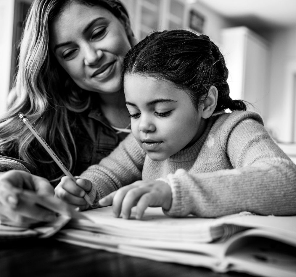 Mother helping daughter with homework