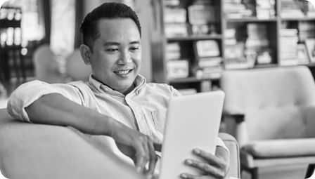 Man smiling and holding a tablet computer