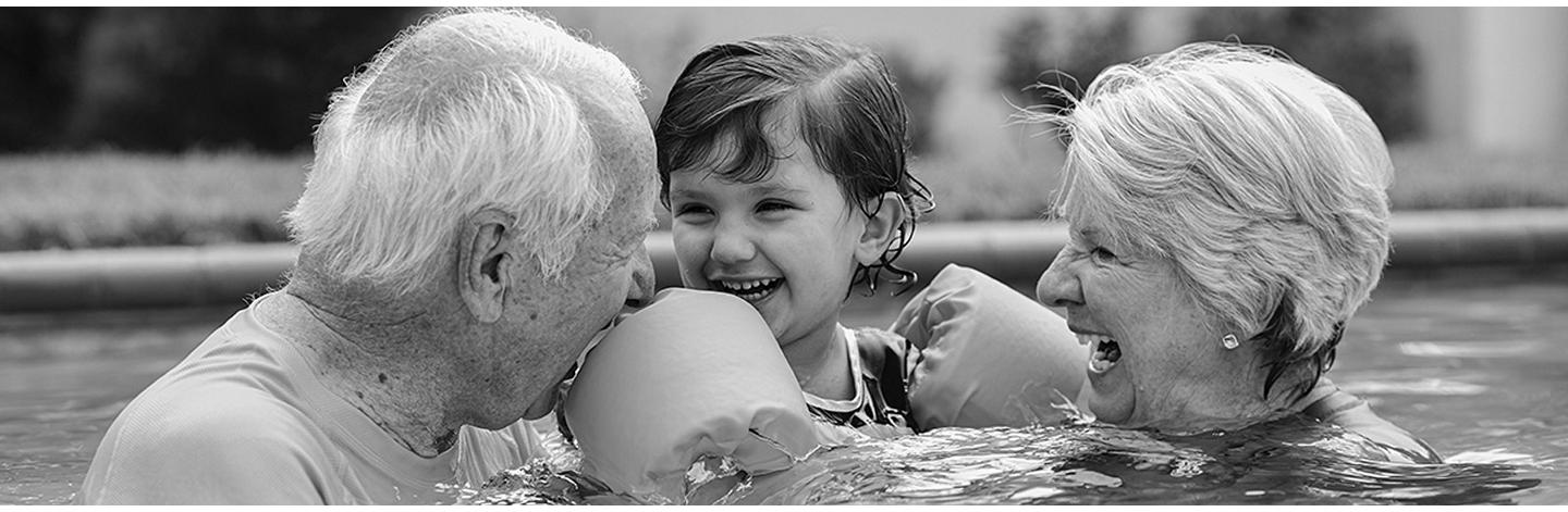 Senior couple with child in pool