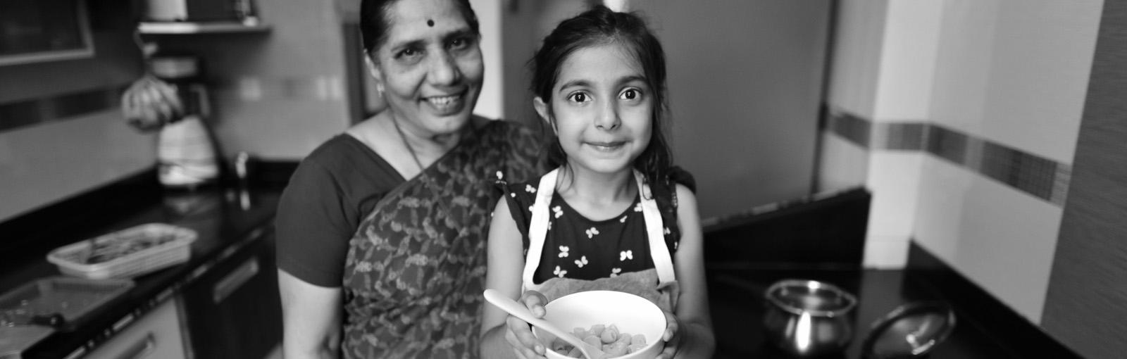 Mother and daughter with food in a bowl