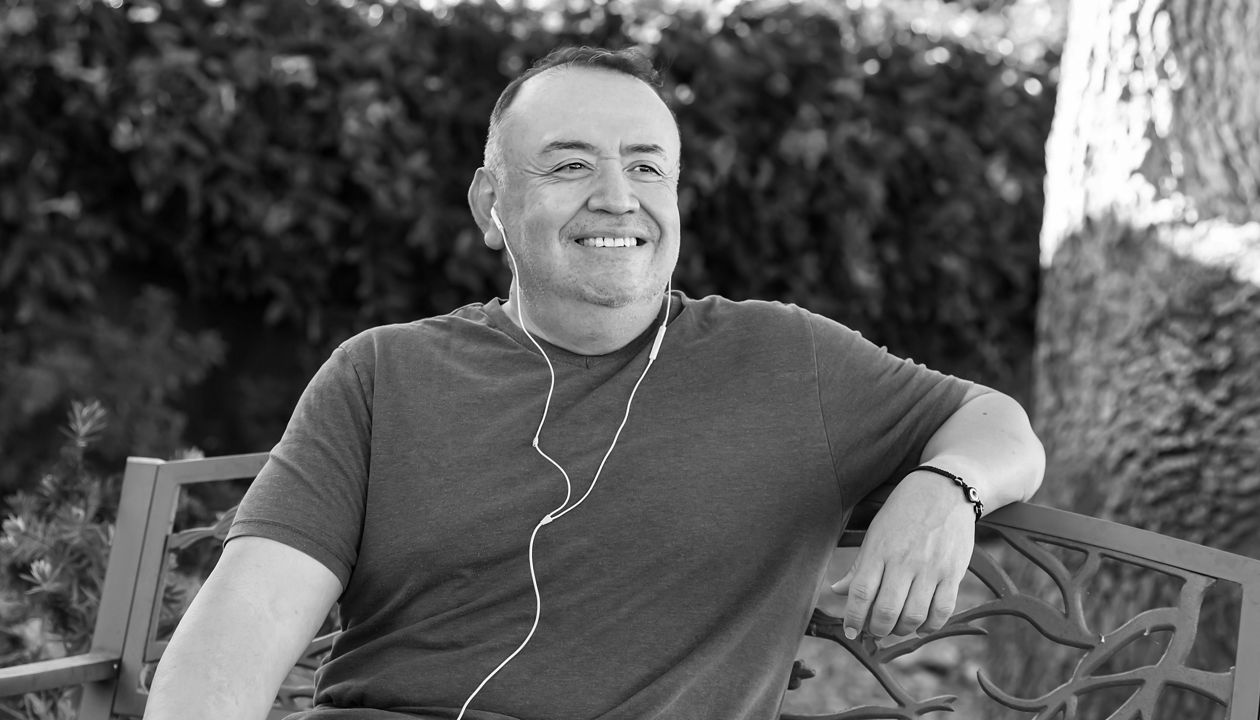 Smiling man sitting with heaphones on