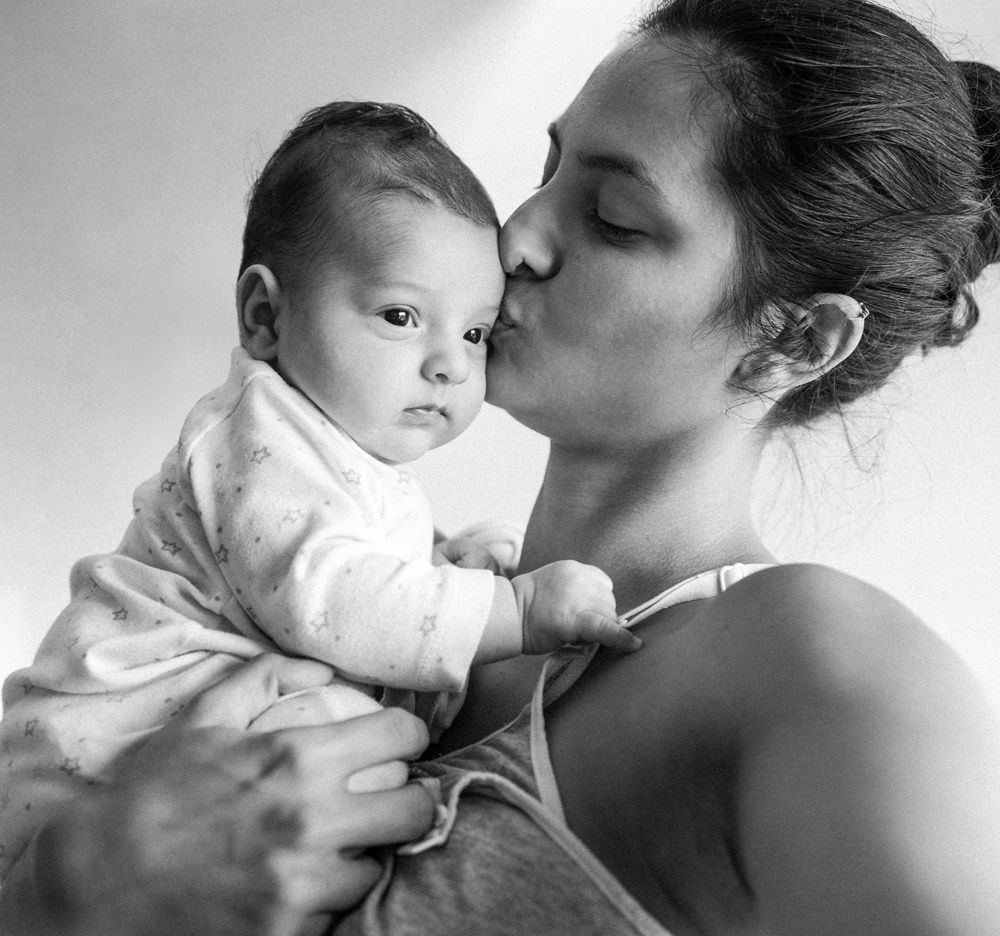 Mother kissing baby