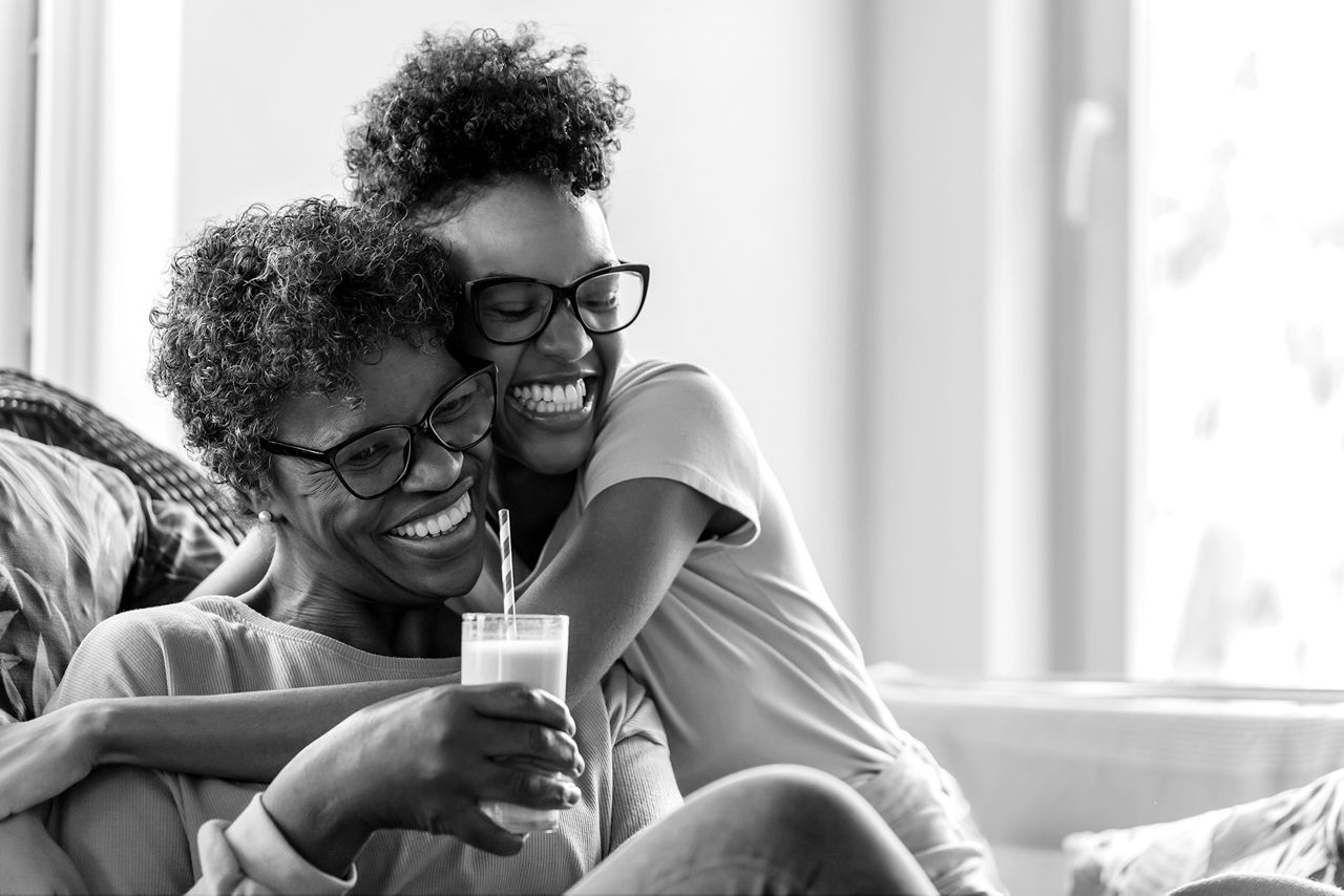 Two happy women laughing and embracing