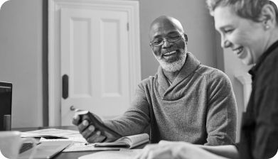 Man laughing at a table