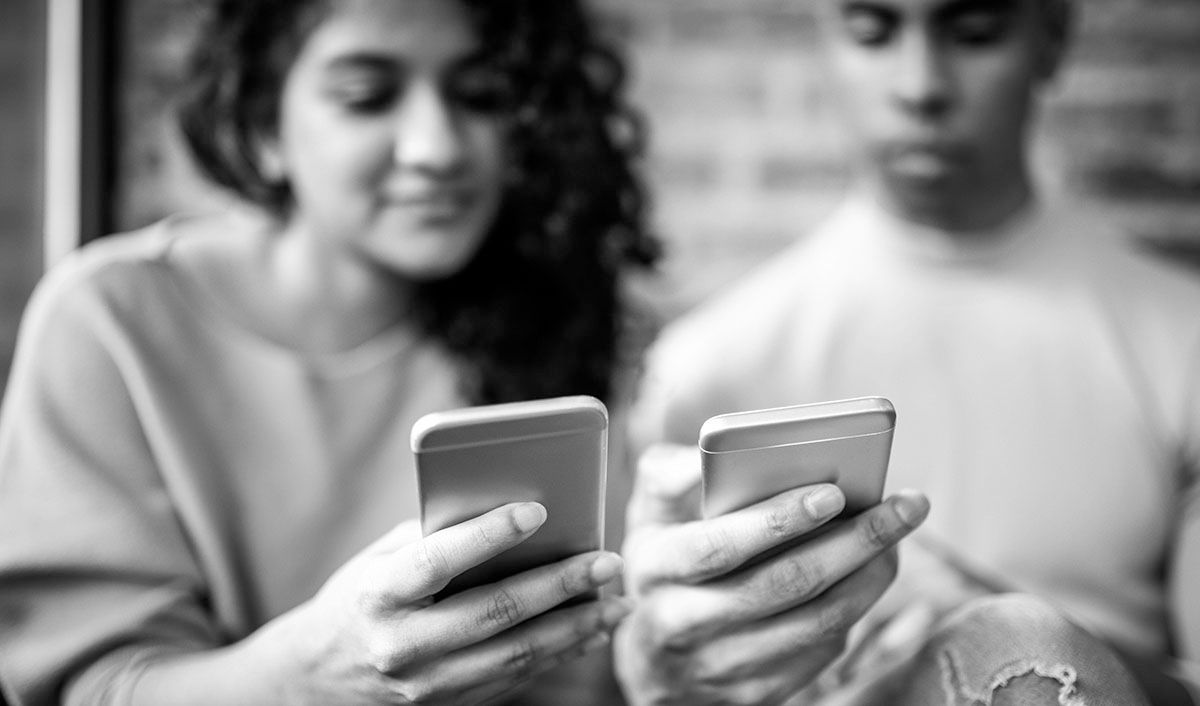 Young man and woman on cellphones