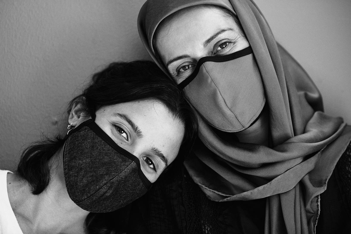Two women wearing masks