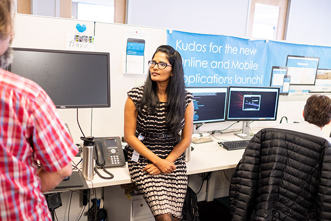 Woman and coworkers in office with computers