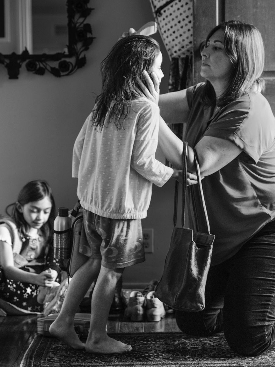 Mother helping daughter with her hair