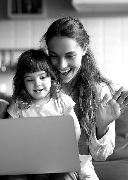 Mother using laptop with daughter