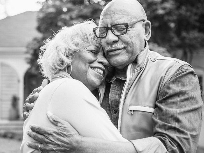  Older man and woman couple smiling and hugging