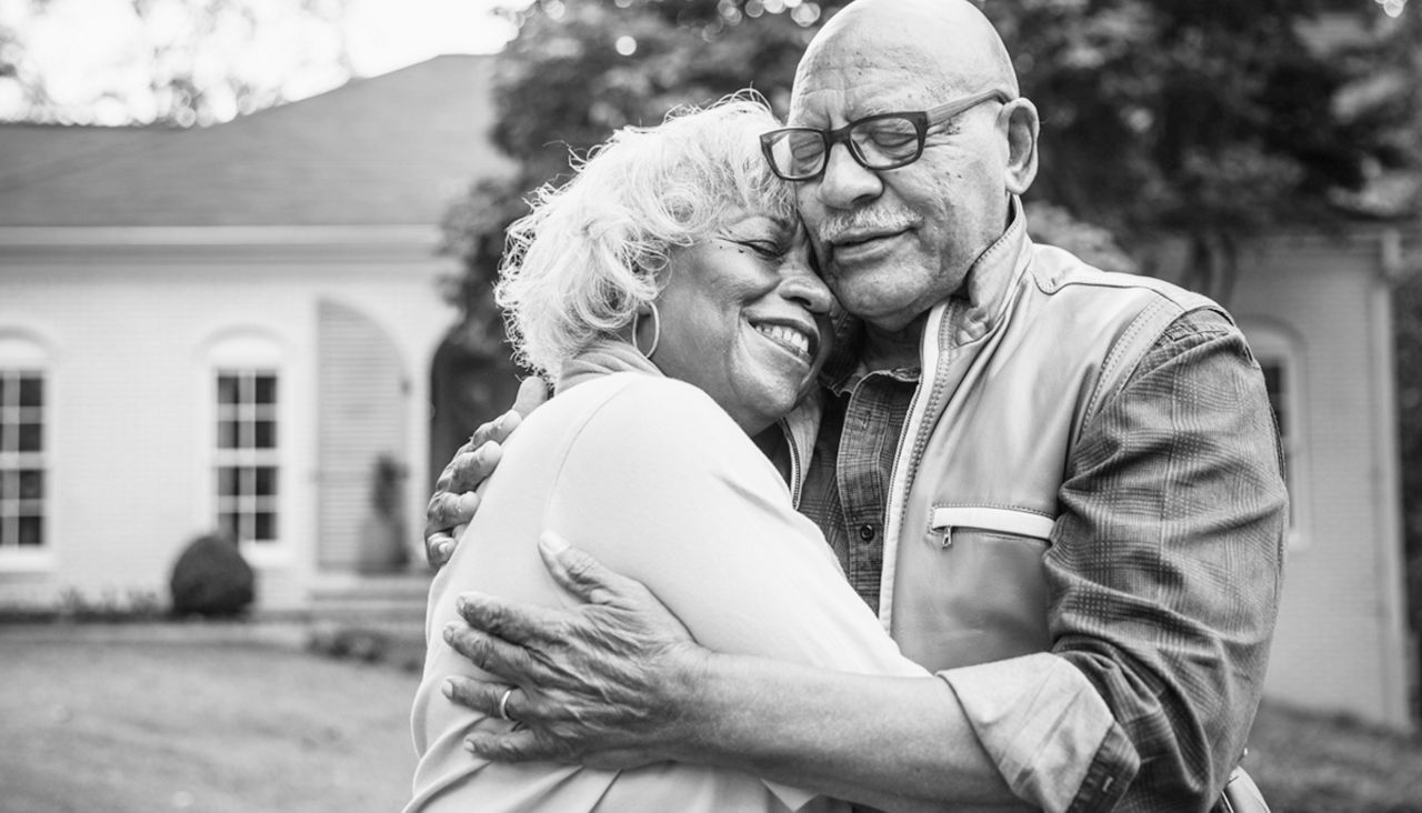  Older man and woman couple smiling and hugging
