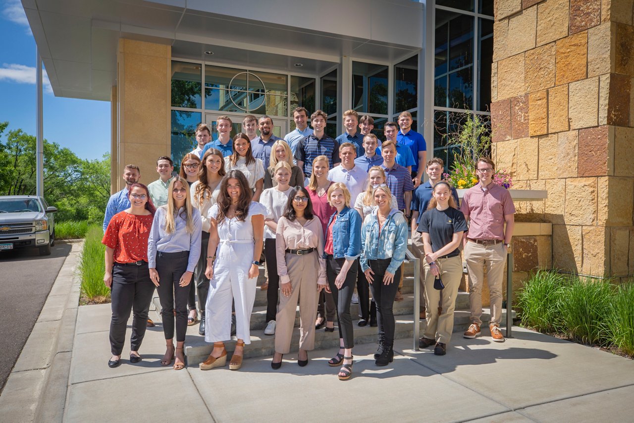 Intern group picture in front of the Cambria building.
