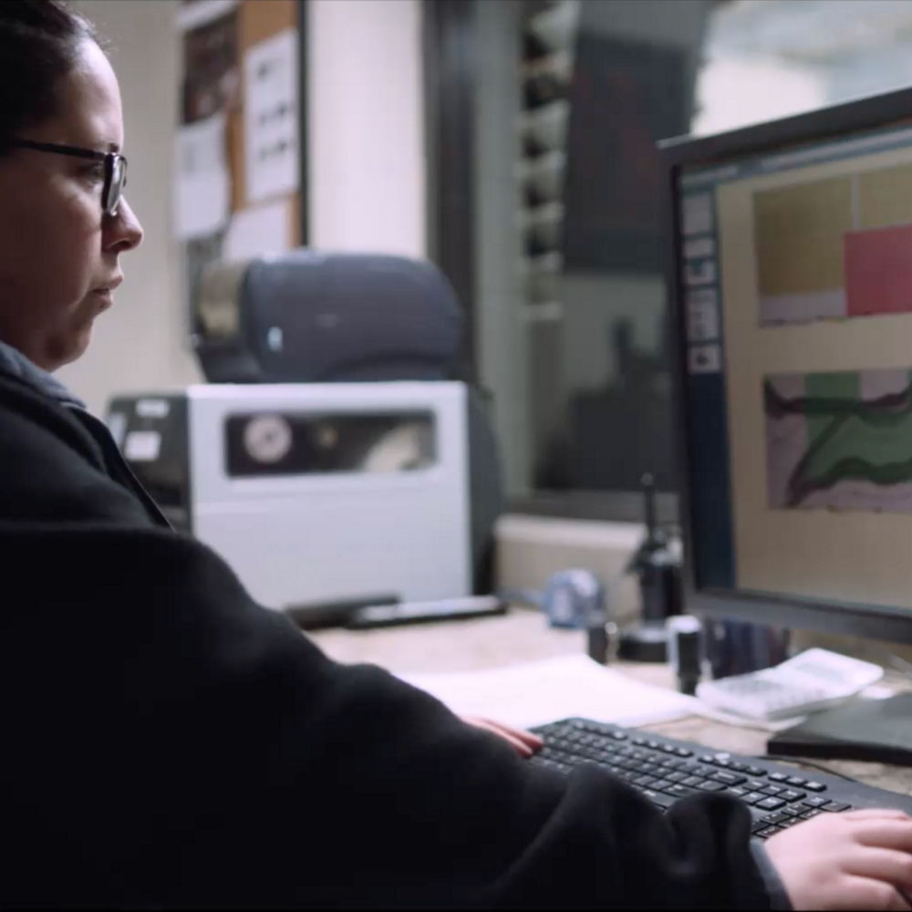 A Cambria employee using special software that creates a blueprint for the best possible flow and pattern continuity throughout your countertops.