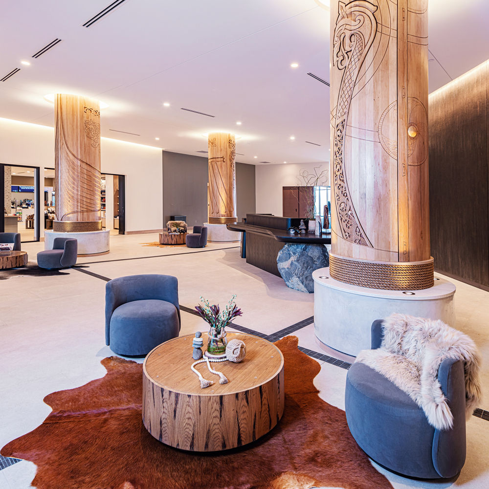 Hotel lobby with lower pillar wraps featuring Cambria Ironsbridge quartz siding.