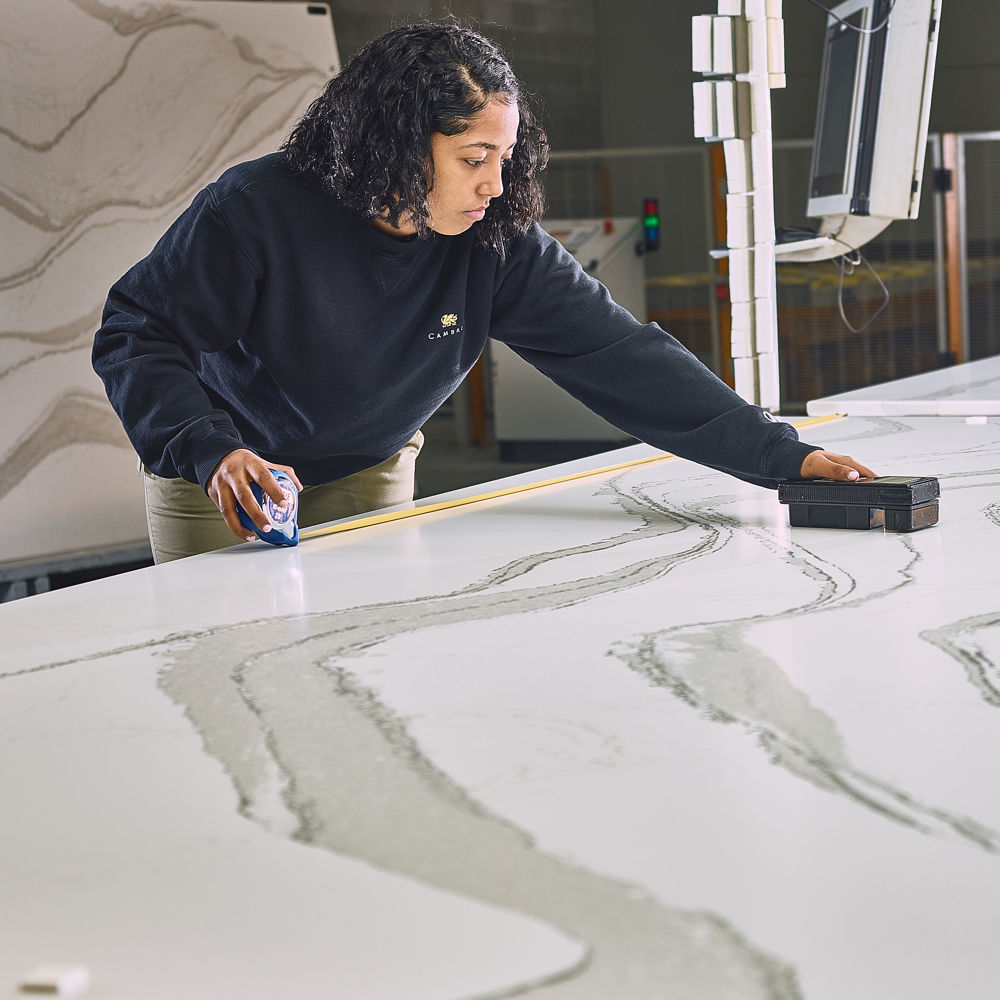 a Cambria employee inspecting a slab so that it is perfect for your installation.