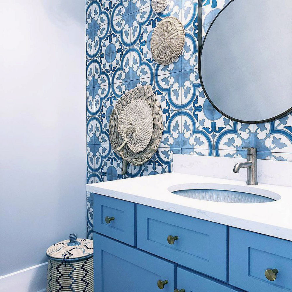 Bathroom with Blue Patterned Tile Walls, A Blue Vanity and A White Quartz Swanbridge™ Countertop