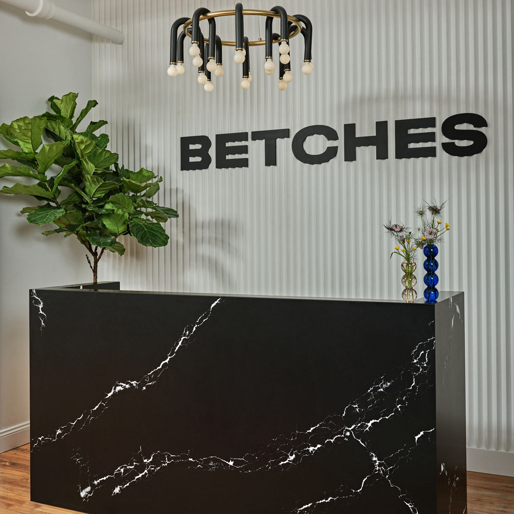 Cambria Blackbrook Matte and White Cliff quartz front desk in Betches headquarters lobby