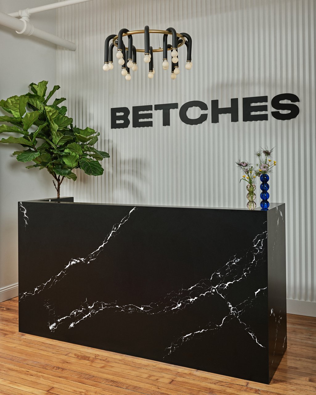 Cambria Blackbrook Matte and White Cliff quartz front desk in Betches headquarters lobby
