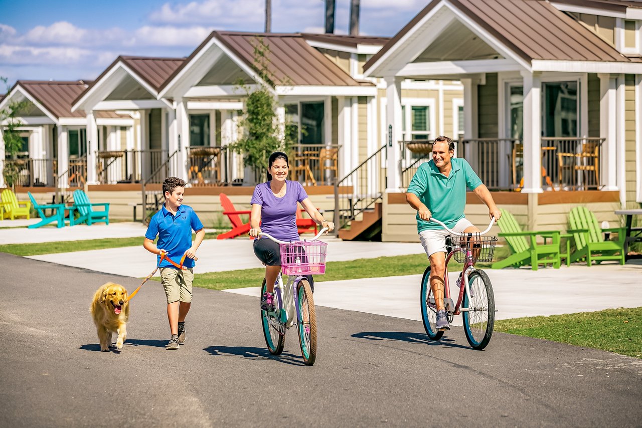 Family biking through a Champion Homes community