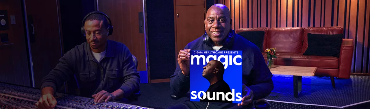 Mr. Earvin "Magic" Johnson in the studio holding up his album, "Magic Sounds"