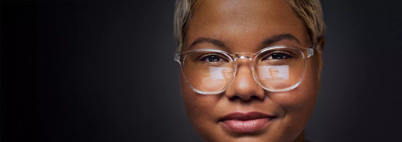 Person looking at computer with a reflection in their glasses