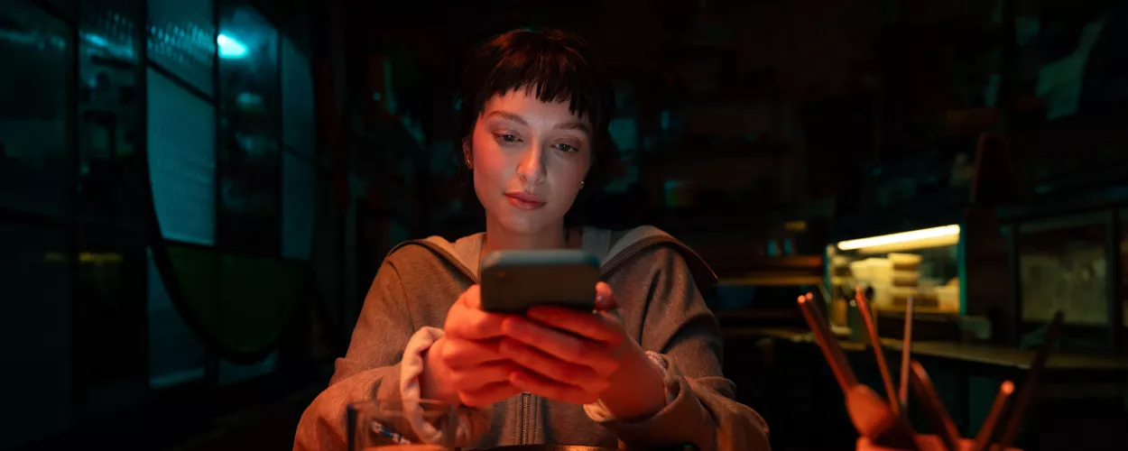 Woman at a restaurant looking at her phone