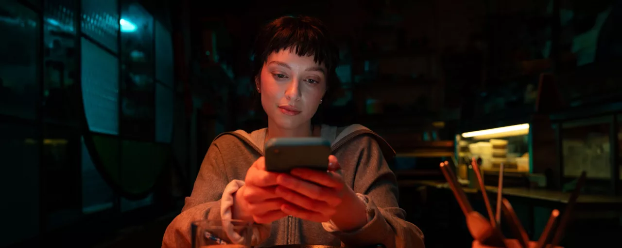 Woman at a restaurant looking at her phone