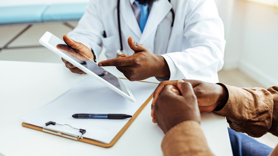 doctor highlighting information on mobile device with index finger