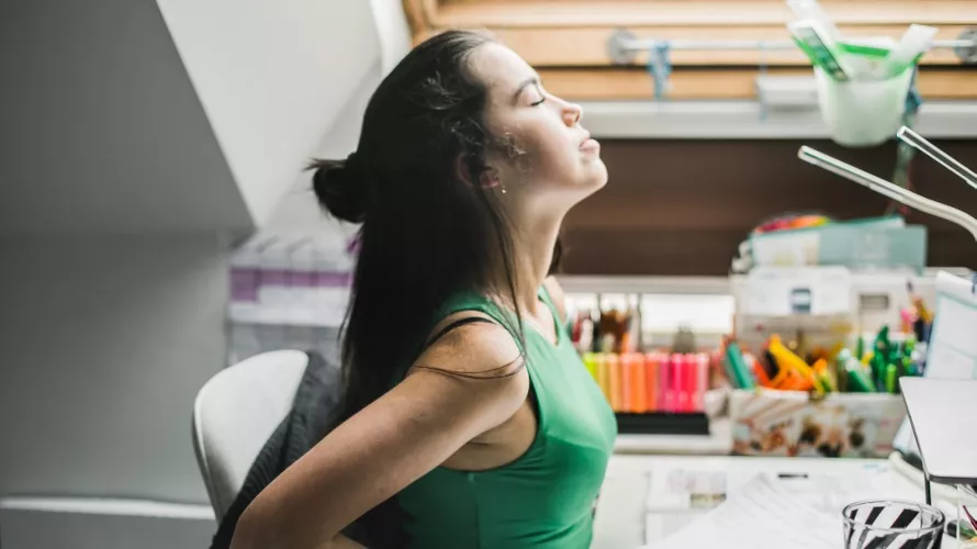 Woman stretching at desk