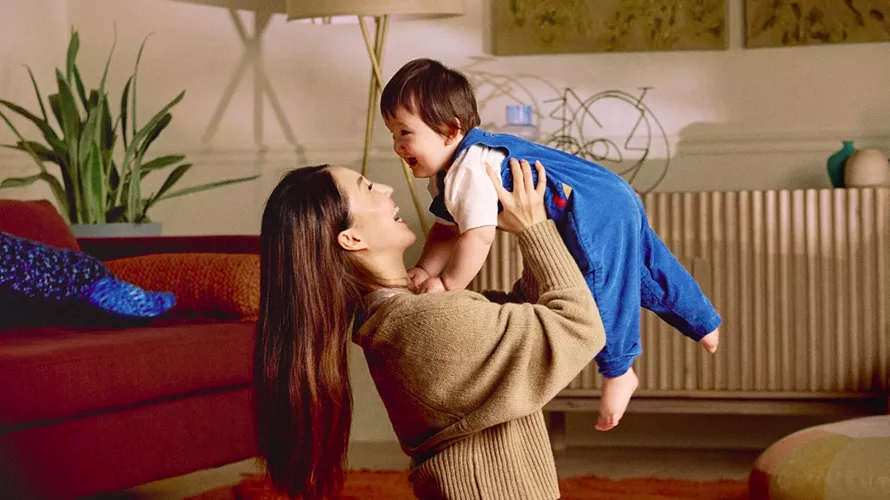 Person holding child in the air