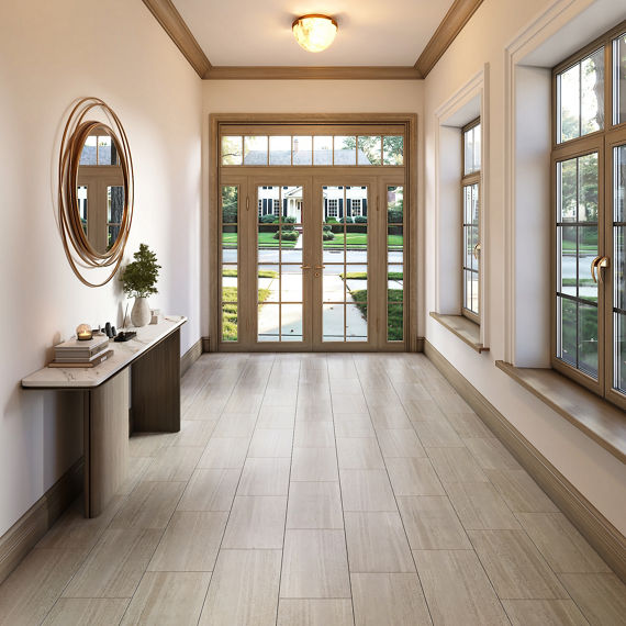 Entry space with wooden floors, white walls, round mirror on side, and gray accents.