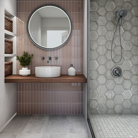 Bathroom with pink subway tile on back wall, white stone look hexagon tile in shower, white stone look square mosaic on shower floor, and white stone look rectangle floor tile.