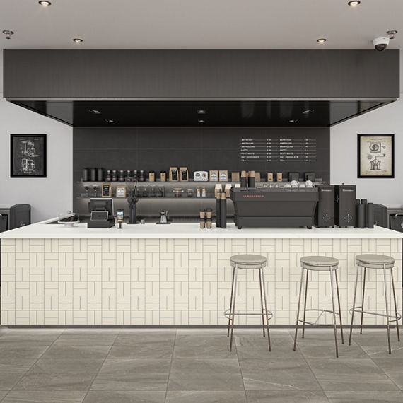Coffee bar with white rectangle tile in basketweave pattern, white bar stools, white countertop, and various coffee supplies.