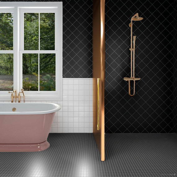 Bathroom with black square tile on shower walls and floor, white square tile on bottom half of back wall, and a pink bathtub.