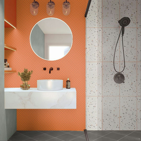 Bathroom with orange square mosaic tile on wall, white terrazzo look rectangle tile on shower walls, and gray square tile on floor.