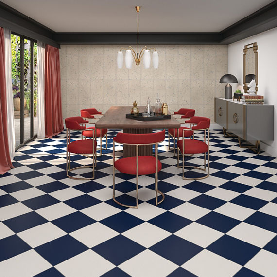 Dining room with white and black checkered floor tile, red chairs, wooden dining table, and beige terrazzo look rectangle tile on back wall.