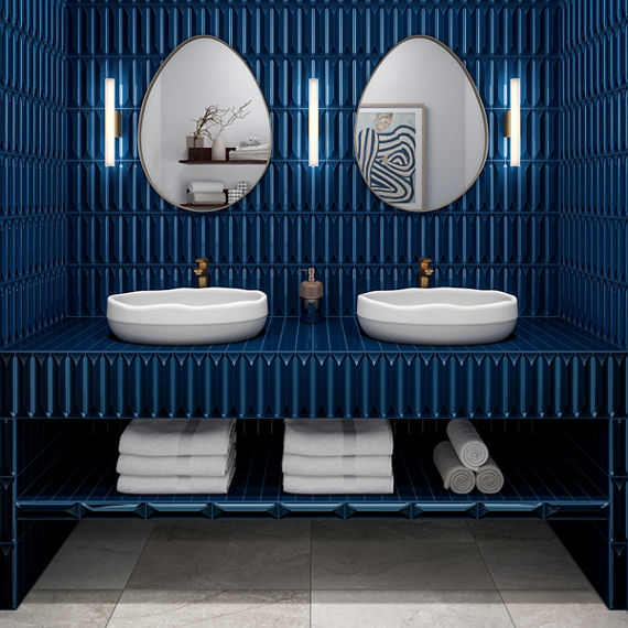 Bathroom with double sinks, oval mirrors above sinks, white square floor tile, and blue rectangle with 3d wave pattern on walls and on sink countertop and counter.