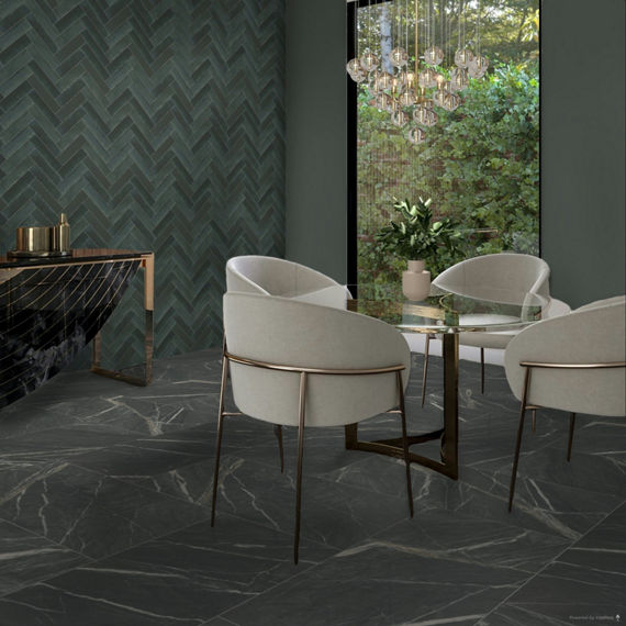 Dining area with black marble look rectangle floor tile, blue subway tile in herringbone pattern on back wall, gray walls, four white chairs, round glass table, and large window showing outdoors.