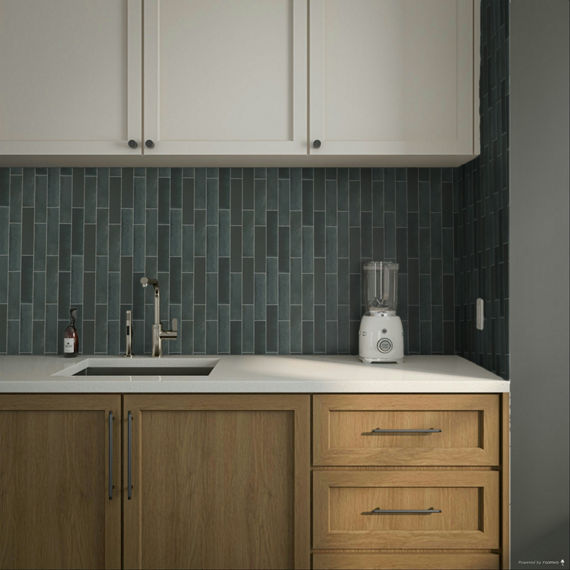 Close up of kitchen with wood cabinets, white countertop, and blue offset vertical rectangle mosaic on backsplash.