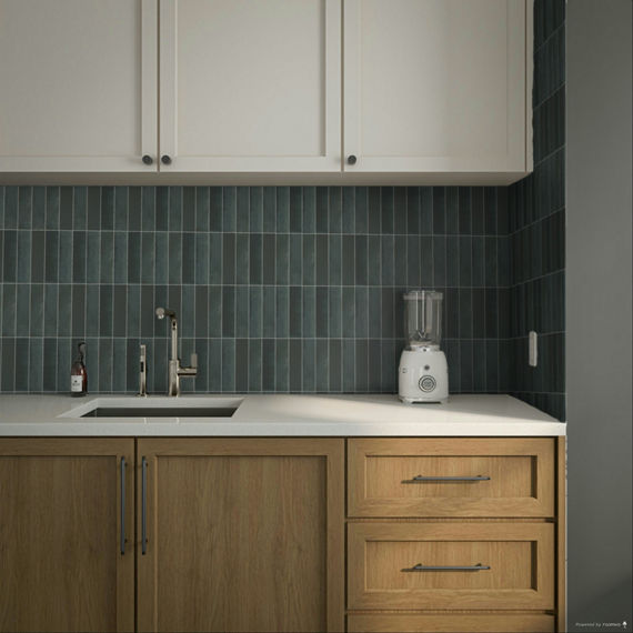 Close up of kitchen with wood cabinets, white countertop, and blue vertical rectangle mosaic on backsplash.