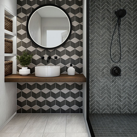 Bathroom with gray encaustic 3d cube design tile on back wall, gray chevron stone look tile on shower wall, gray square stone look mosaic tile on shower floor, white stone look rectangle floor tile, wood counter, white sink, and black accents.